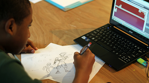 A student refines his character design for a video game.