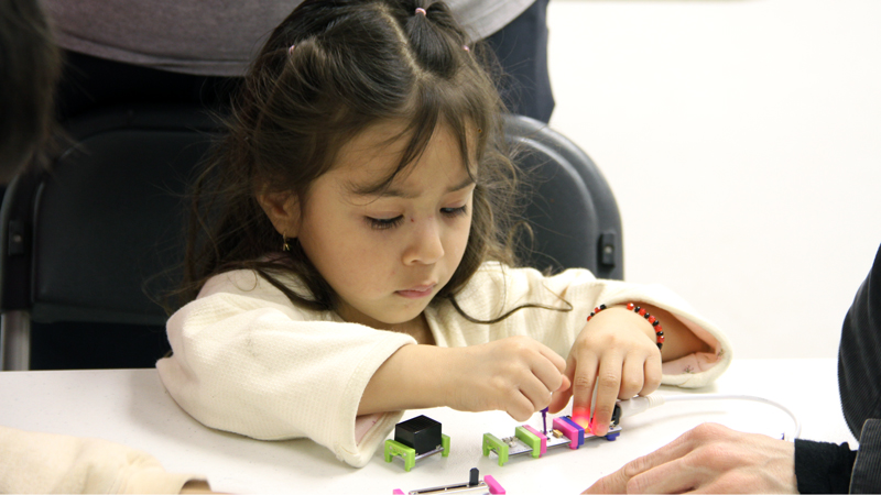 A young participant adjusts a littleBit.