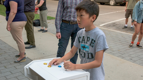 A young visitor tries out a game. Photo courtesy Robert Banke.