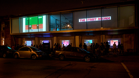 As the sun set, the games were visible on the side of the building and on the 2nd floor video projections.
